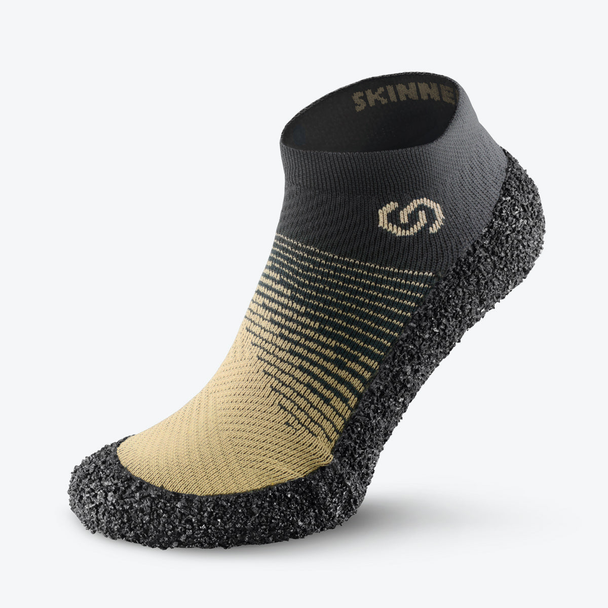 Side view of sand-colored Skinners sock shoe, showcasing its sleek design and durable sole.