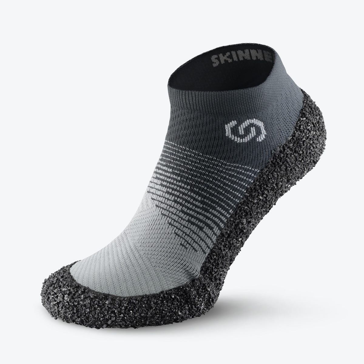 Side view of stone-colored Skinners sock shoe, emphasizing its modern design and supportive sole.