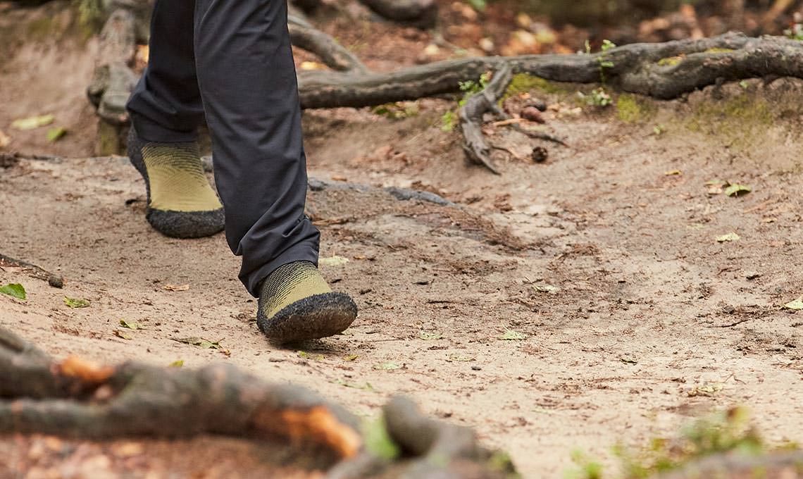 A vibrant lifestyle image of Skinners' micro-crew Compression 2.0 Barefoot Sock Shoe in Sand, ideal for packing on any weekend trip, ideal for everyday wear or outdoor activities.
