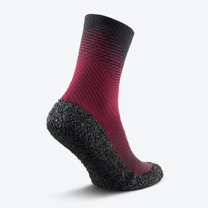 Back view of Carmine red Skinners compression socks, highlighting their reinforced heel and contoured fit.